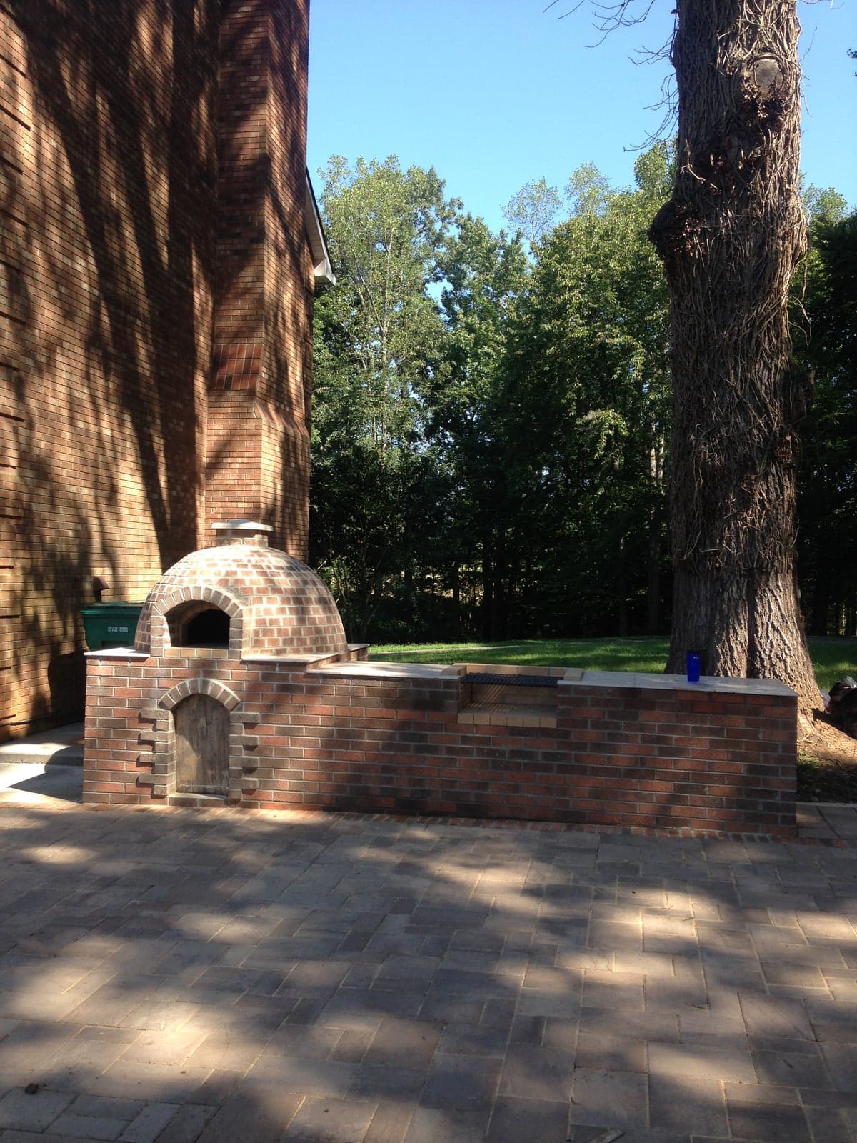 Wide brick walkway and patio with brick chimney structure