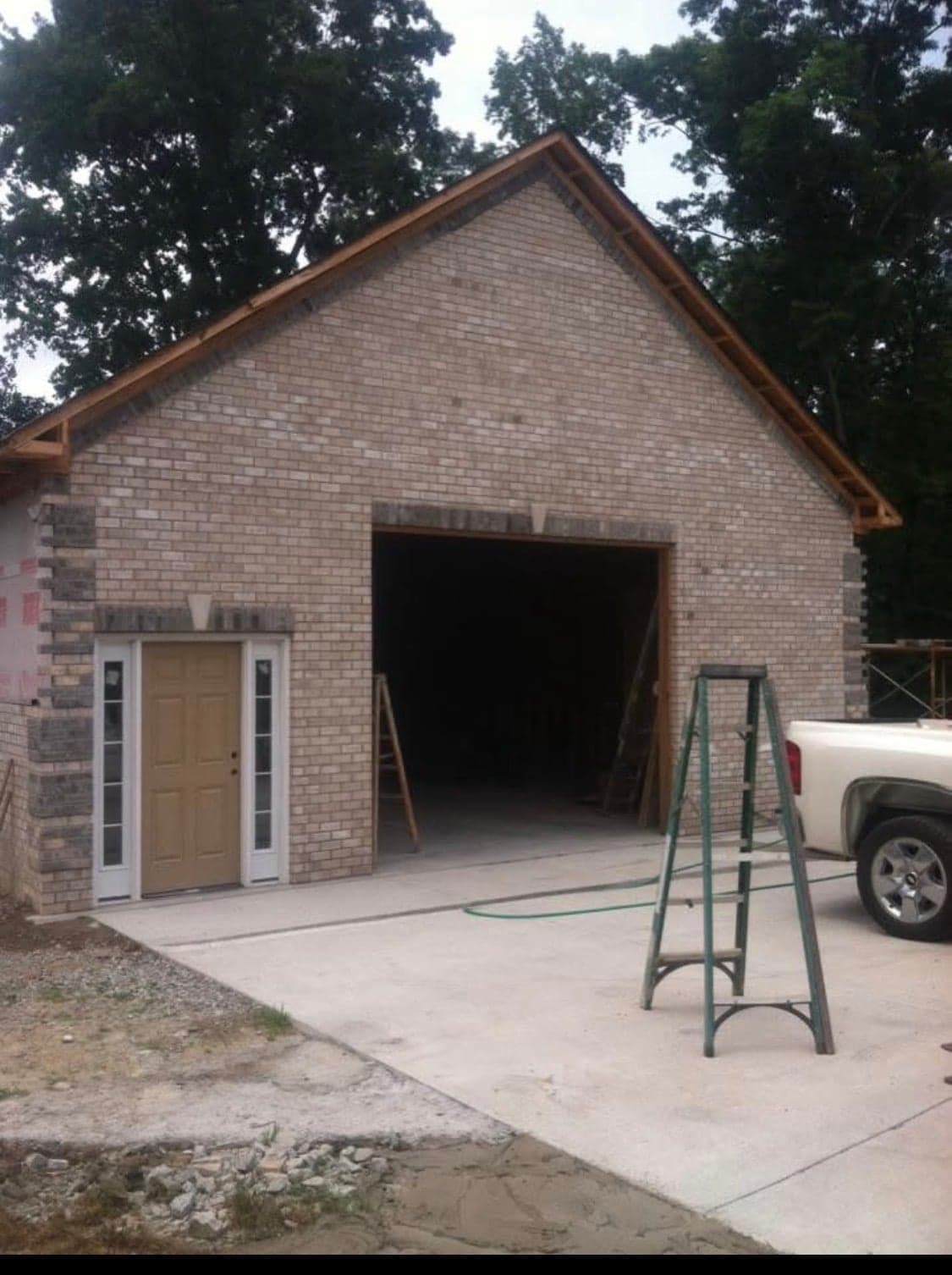 Brick garage building with stone foundation accent