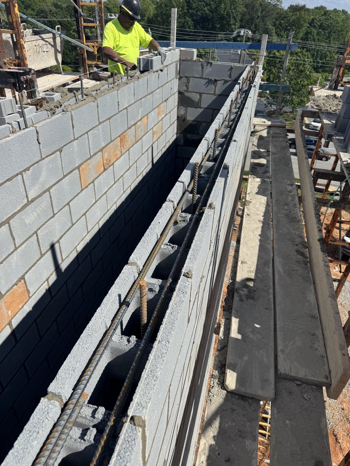 Mason laying block on a commercial foundation