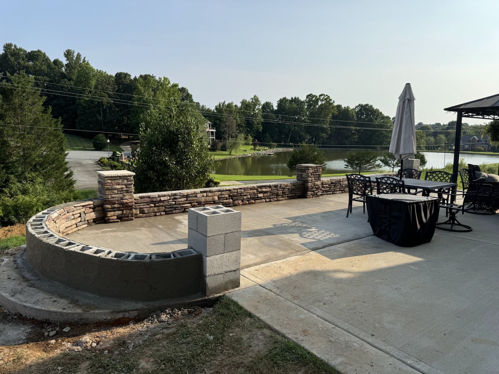 Stone seat wall and patio overlooking a lake
