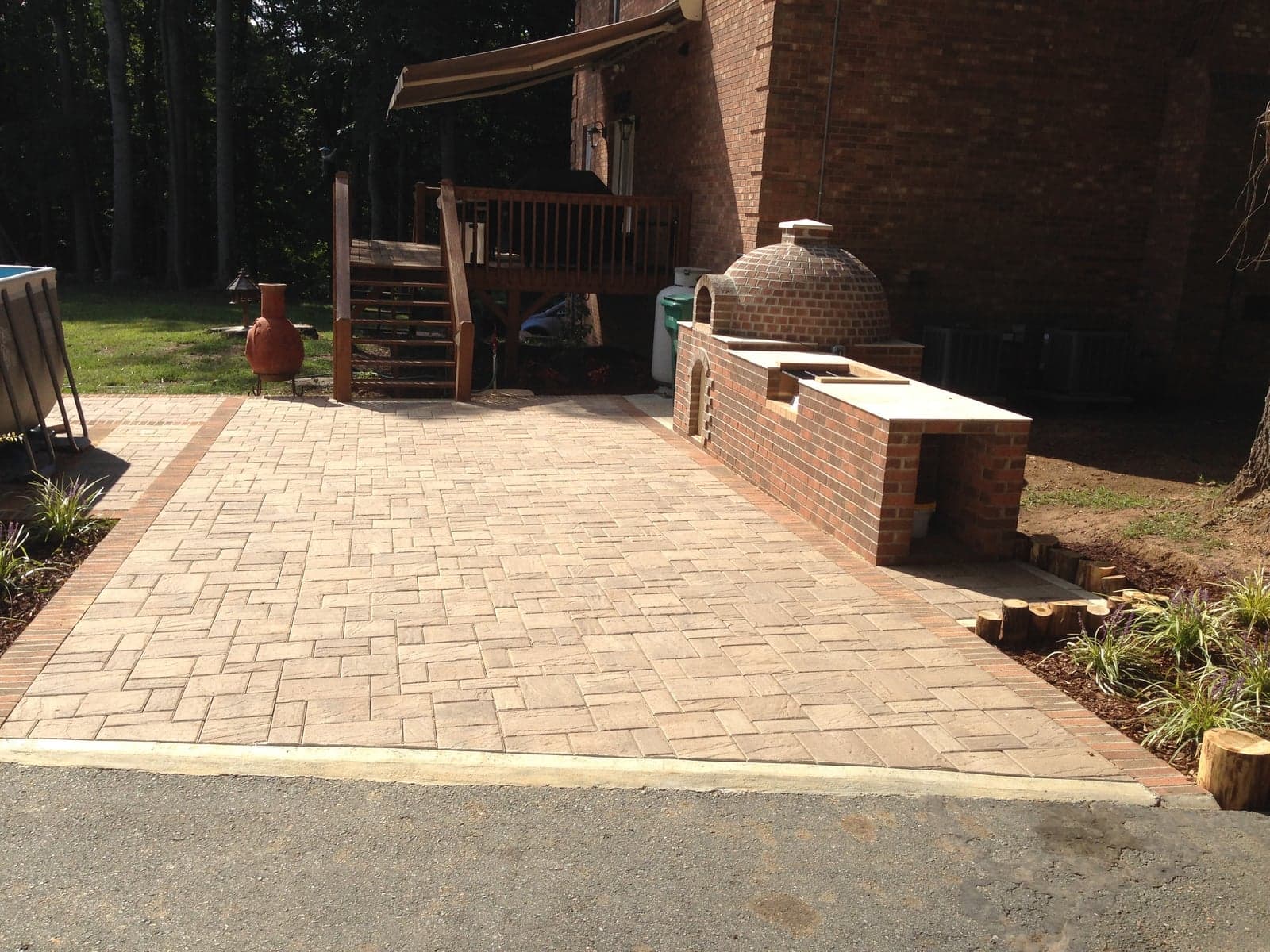 Stamped concrete patio with brick outdoor pizza oven
